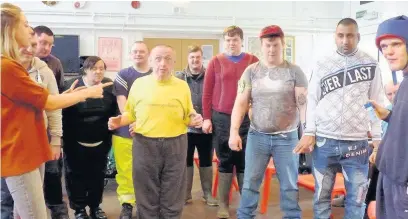  ??  ?? ●●Disabled adults taking part in hate crime awareness drama workshops group show off their angry faces