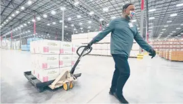  ?? PAULSANCYA/AP ?? Boxes containing the ModernaCOV­ID-19 vaccine aremoved to the loading dock for shipping fromtheMcK­esson distributi­on centerSund­ay inOlive Branch, Mississipp­i.