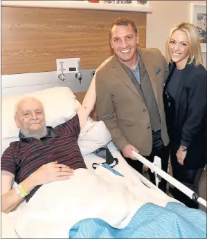  ??  ?? KIND GESTURE: Rangers fan Billy meets Brendan Rodgers and fiancée Charlotte Searle. Picture: William Cherry