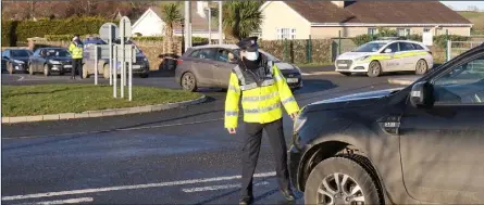  ??  ?? Gardai carry out a checkpoint at the Milehouse Road roundabout in Enniscorth­y last weekend.