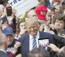  ?? REUTERS PHOTO ?? WHAT’D HE SAY? Donald Trump appears among supporters in Plymouth, N.H., during the 2016 campaign.