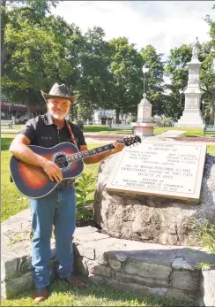  ?? Jim Moore / Contribute­d photo ?? Singer Jim Moore recently made a CD with his original song, “Mad River” which remembers the Flood of ’55 and its devastatin­g impact on the town of Winsted. Above, Moore visits Winsted’s East End Park, where a monument honoring the victims of the flood now stands.