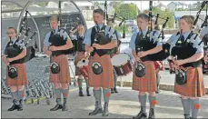  ?? 16_T36_M&S07 ?? Oban High School Pipe Band kept the queue entertaine­d.