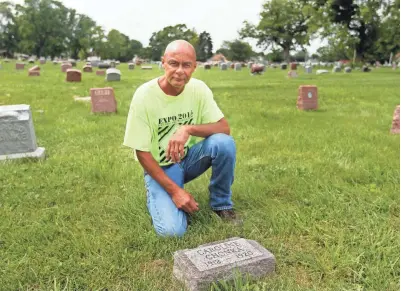  ?? ANGELA PETERSON / MILWAUKEE JOURNAL SENTINEL ?? Jim Staniszews­ki kneels at the grave of Caroline Chonka at Union Cemetery in Milwaukee. The girl died in 1920. He found a different tombstone for her on farmland near his home in Muskego. See more photos at jsonline.com/news.