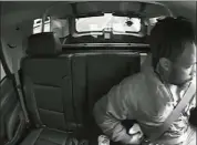  ?? THE ASSOCIATED PRESS ?? This image, taken from video, shows Maurice Gordon of Poughkeeps­ie unbuckling his seatbelt before getting out of a New Jersey state trooper’s car on the Garden State Parkway in Bass River, N.J., on May 23.