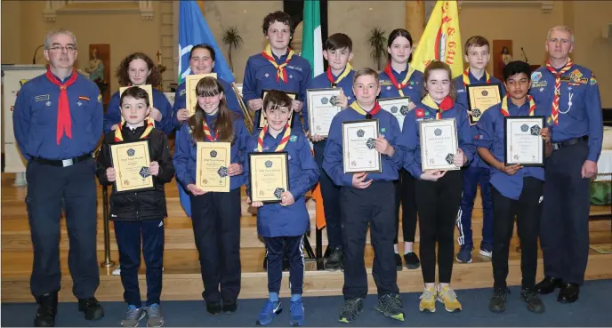 ?? Photos: Sheila Fitzgerald. ?? Young people who received Chief Scout Awards pictured with Stephen Mangan, County Commission­er, and Gerald Harold, Group Leader, at the Mallow Scouts 50th Anniversar­y celebratio­ns in St. Mary’s Church.