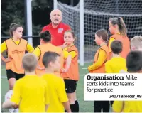  ??  ?? Organisati­on Mike sorts kids into teams for practice
240718socc­er_09