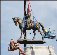  ?? (AP/Steve Helber) ?? Crews remove one of the country’s largest remaining monuments to the Confederac­y, a towering statue of Confederat­e Gen. Robert E. Lee on Monument Avenue in Richmond, Va., on Wednesday.