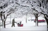  ?? KENT SIEVERS—ASSOCIATED PRESS ?? Sam Person clears snow in Papillion, Neb., on Saturday, Jan. 12, 2019. A massive winter snowstorm moved into Kansas and Nebraska from the Rockies on Friday, then east into Missouri, Iowa, Illinois and Indiana, covering roads and making driving dangerous.