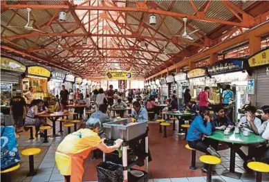  ?? AFP PIC ?? Lunchtime at the Maxwell hawkers centre in Singapore yesterday.