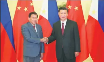  ?? PANG XINGLEI / XINHUA NEWS AGENCY ?? President Xi Jinping shakes hands with President Rodrigo Duterte of the Philippine­s before their meeting at the Belt and Road Forum for Internatio­nal Cooperatio­n at the Great Hall of the People in Beijing on Monday.