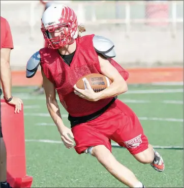  ??  ?? Vilonia sophomore quarterbac­k Nick Lewis turns upfield.