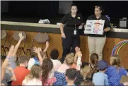  ?? ?? Vacaville Public Safety, Sarah Dahl (left), and Community Service Officer, Amber McCabe speaks to the kids of Vacaville’s Camp Splash Friday at the Three Oaks Community Center. Campers were taught about the proper usage of the 911 phone lines and other functions the department does to keep the community safe.