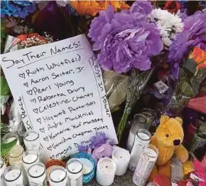  ?? AFP PIC ?? The names of the 10 people killed in Saturday’s shooting at Tops market are part of a makeshift memorial across the street from the store in Buffalo, New York, the US, on Tuesday. The attack was believed to be motivated by racial hatred.