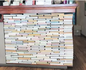  ?? — THE ASSOCIATED PRESS ?? The checkout counter at an indie bookseller in Newton, Mass., is made of rows of backward books glued into place, a take on the recent backward bookshelf craze.