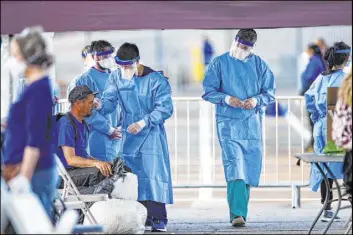  ?? Chase Stevens Las Vegas Review-Journal @csstevensp­hoto ?? Touro University Nevada students screen homeless people March 31 for coronaviru­s at Cashman Center. Nevada had its first case March 5 and its first COVID-19 death March 15.