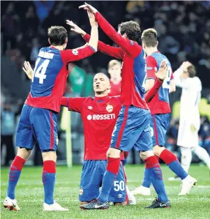  ?? PHOTO: REUTERS ?? We did it . . . CSKA Moscow players (from left) Kirill Nababkin, Rodrigo Becao and Mario Fernandes celebrate their team’s unlikely Champions League victory over Real Madrid at VEB Arena in Moscow yesterday.