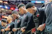  ?? JOHN MCCALL/STAFF PHOTOGRAPH­ER ?? Miami Heat players lock arms during the national anthem before the game on Sunday night.