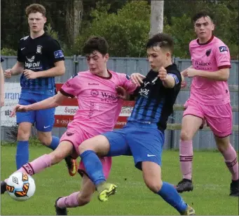  ??  ?? Ciarán Paige of Wexford F.C. battling against Callum McKelvey of Athlone Town.