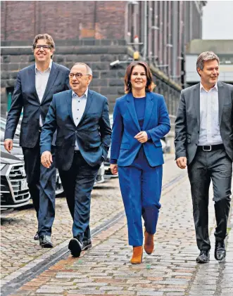  ?? ?? Olaf Scholz, centre, the incoming chancellor, with members of the SPD, FDP and the Green Party after the final round of coalition talks