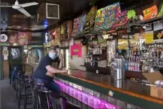  ?? Emily Matthews/Post-Gazette ?? Chris Dawso, the owner of Jack’s Bar on the South Side, talks on the phone as he gets the bar ready to reopen on Friday. Jack’s planned to reopen on Easter Sunday after being closed for a year.