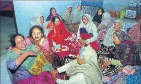  ??  ?? Grieving family members of Lance Naik Gurmail Singh at Alkara village in Amritsar on Saturday; and (below) his father showing the family photograph. SAMEER SEHGAL/HT