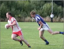  ??  ?? An Ghaeltacht’s Padraig O Sé is marked by Pat Spillane, Templenoe, in their County SFL match. Photo by Mary O’Neill