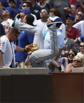  ?? Associated Press ?? Into the stands: Tampa Bay Rays third baseman Evan Longoria (3) chases a foul ball and falls over the wall during the fifth inning of a baseball game against the Chicago Cubs on Wednesday in Chicago.