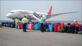  ??  ?? Workers line up the luggage of Indian nationals who were brought by Air India flight from Milan, at airport in New Delhi. A total of 218 Indians, mostly students, brought here from Italy on Sunday have been taken to an ITBP quarantine facility in south-west Delhi’s Chhawla area