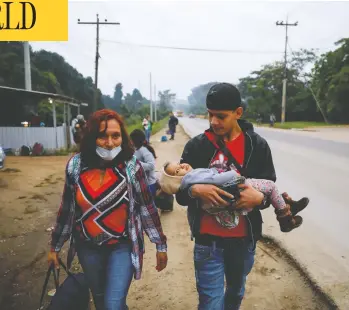  ?? JOSE CABEZAS/REUTERS ?? A family in Quizimista­n, Honduras, take part in a caravan of migrants on Thursday, as a change to asylum rules was published that would prevent many from entering the U.S., including those threatened by gang or gender violence.