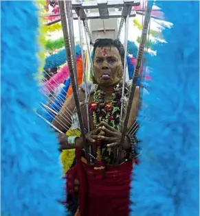  ??  ?? A devotee participat­es in a Hindu festival in Yangon. Although only an estimated two per cent are Hindus in this majority Buddhist country, most of them being Myanmar Indians, Hindu influences can be found in the language, culture and the architectu­re...