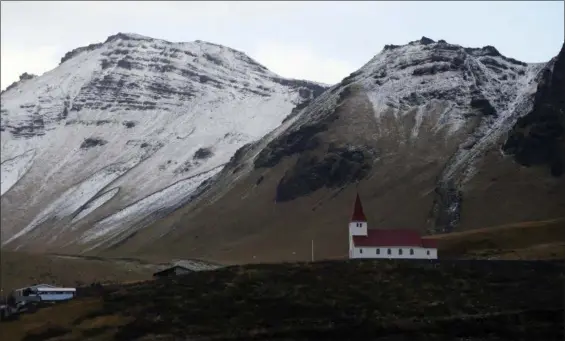  ?? FRANK AUGSTEIN — THE ASSOCIATED PRESS FILE ?? In this file photo, the church of Vik, Iceland, near the Volcano Katla, After a summer of increased seismic activity at Katla, Icelanders are obsessing over the smallest sign of an eruption at the country’s most closely watched volcano. Katla last...