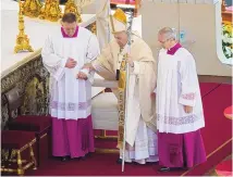  ?? GREGORIO BORGIA/ASSOCIATED PRESS ?? Pope Francis is helped as he celebrates the canonizati­on Mass for 10 new saints in St. Peter’s Square at the Vatican on Sunday.