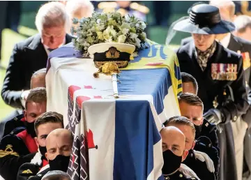  ??  ?? ■ Pall Bearers carrying the coffin of the Duke of Edinburgh enter St George’s Chapel at Windsor Castle