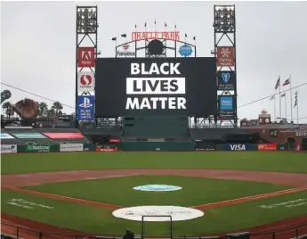  ?? LACHLAN CUNNINGHAM/GETTY IMAGES ?? “Black Lives Matter” fills the digital screen at Oracle Park in San Francisco.