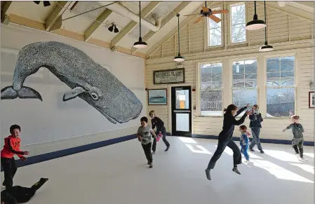  ?? DANA JENSEN/THE DAY ?? Children play in the indoor sock skating rink located in The Galley during the Ice Festival on Saturday at Mystic Seaport.