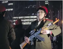  ??  ?? Chinese women wearing military costumes march with toy guns during exercises in Beijing. The group is taking part in a health trend for seniors that has filled squares and apartment courtyards across China.