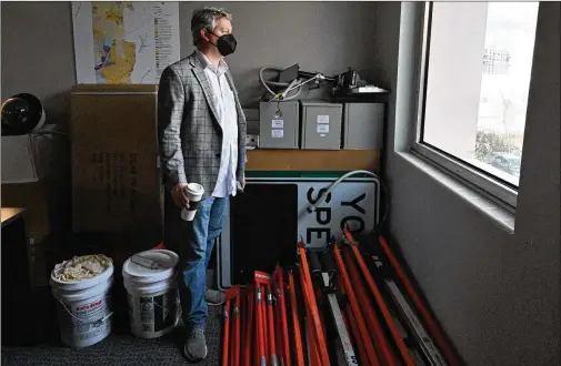  ??  ?? Brookhaven Mayor John Ernst stands amid items stored in the meeting room at Brookhaven City Hall last month since meetings went virtual due to the pandemic. Brookhaven became the first city in the state to close its City Hall and was among the first to send nonessenti­al workers home to work virtually.