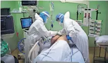  ?? [DANIEL COLE/ THE ASSOCIATED PRESS] ?? A medical crew treats a COVID-19 patient Wednesday in the intensive care unit at the Joseph Imbert Hospital Center in Arles, southern France.