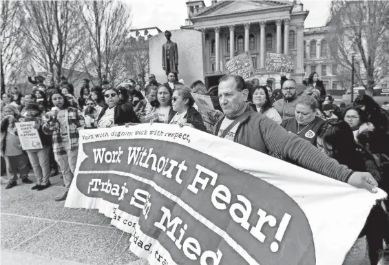  ?? PHOTOS BY THOMAS J. TURNEY/STATE JOURNAL-REGISTER ?? Protesters hold signs up signs during an immigratio­n rally in front of the state Capitol March 21 in Springfiel­d.