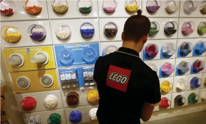  ??  ?? An employee at a Lego store in Paris. Photograph: François Mori/AP