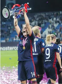  ?? — THE ASSOCIATED PRESS ?? Ada Hegerberg hoists the Champions League Cup following Lyon’s 4-1 win over Wolfsburg in Kyiv, Ukraine on Thursday.