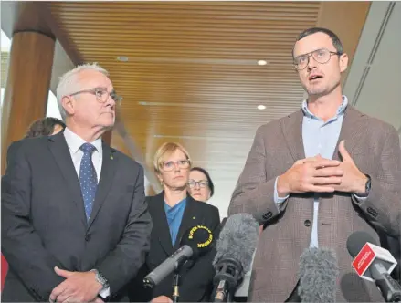  ?? Picture: MICK TSIKAS/AAP IMAGE VIA AP) NO ARCHIVING ?? Independen­t member of parliament Andrew Wilkie, left, and Julian Assange’s brother Gabriel Shipton, right, speak to the media at Parliament House in Canberra, Thursday, February 15, 2024. Australia’s House of Representa­tives has passed a motion calling on the United States and the UK to end the prosecutio­n of WikiLeaks founder Julian Assange and for him to be allowed to return to his home country.