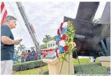  ?? LEE HERSHFIELD/COURTESY ?? Palm Beach County: James Holmes, of Wellington, reads a plaque that describes the origins of one of the largest steel beams recovered from the World Trade Center after the attacks and is now displayed in Wellington.