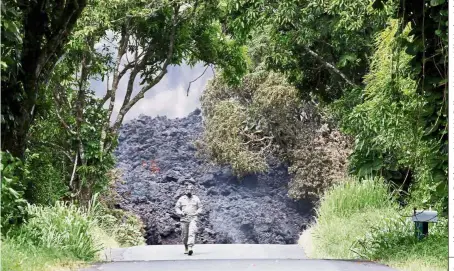  ?? — Reuters ?? Highway to hell: Lt- Col Charles Anthony, of the Hawaii National Guard, measuring sulphur dioxide levels at a lava flow on Highway 137 near Pahoa during eruptions of the Kilauea Volcano in Hawaii.