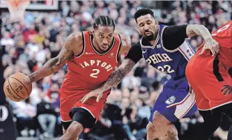  ?? FRANK GUNN THE CANADIAN PRESS ?? Raptors’ Kawhi Leonard, left, drives past 76ers’ Wilson Chandler on Wednesday. Toronto won, 113-102.