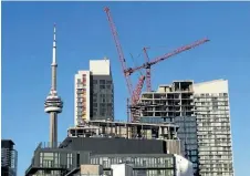  ?? FRANK GUNN/THE CANADIAN PRESS ?? Constructi­on cranes are seen in Toronto on July 5, 2017.