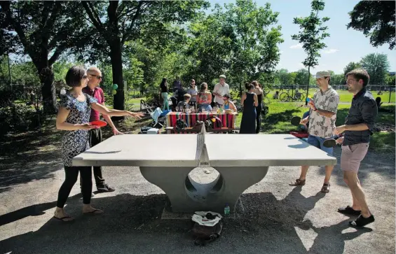  ?? GAZETTE PHOTOS: VINCENZO D’ALTO (ABOVE), PETER MCCABE (BELOW) ?? Montreal’s green spaces get a makeover: At Laurier Park in the Plateau Mont-Royal borough, Saskia Hawkins, from left, Gavin Wickens, François Belisle and Paul Tetreault enjoy a game of table tennis, while Cavalli family members (below) enjoy a late...