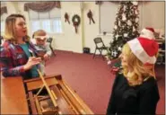  ?? BOB KEELER — DIGITAL FIRST MEDIA ?? Jill Saurmelch, of Gilbertsvi­lle, holds her 6-month-old daughter, Anna, while talking to Sandra Moyer, the wife of Franconia Police Sgt. George Moyer, at the Breakfast with Santa in Franconia. The Dec. 9 breakfast was a fundraiser for this year’s...