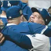  ?? Robert Gauthier Los Angeles Times ?? MANAGER Dave Roberts and the Dodgers rejoice after defeating Tampa Bay to win the World Series.